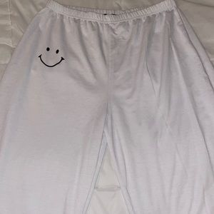 white smiley sweatpants